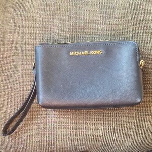 Michael Kors double zip wristlet. In black with gold zipper and logo.